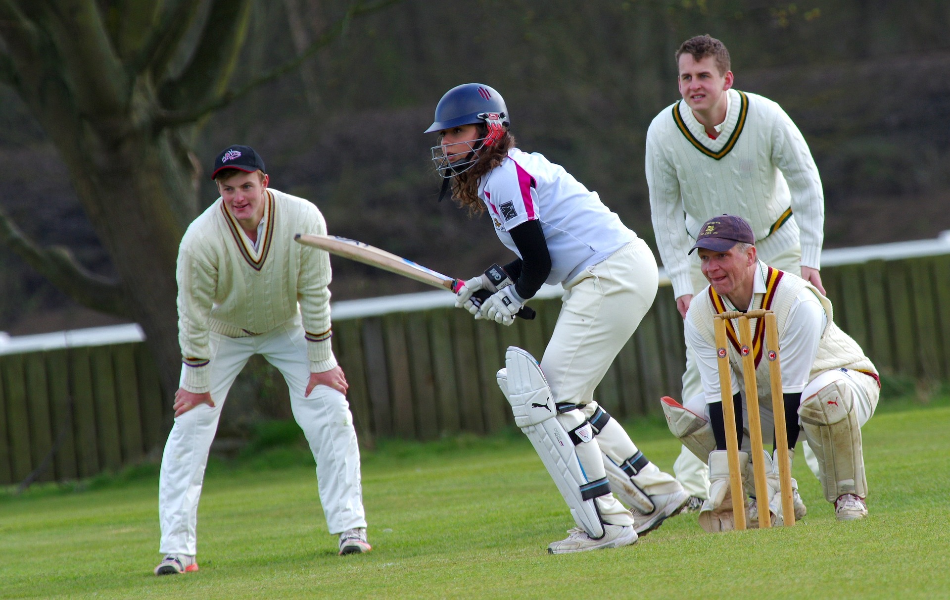 People playing cricket to encourage cricketer